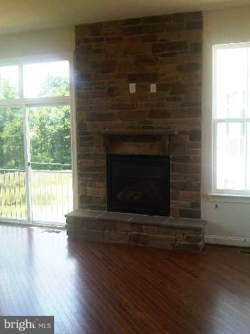 9839 Garden Ranges Laurel, MD 20723 - Photo 10 of 12 a living room with a fireplace and wooden floor