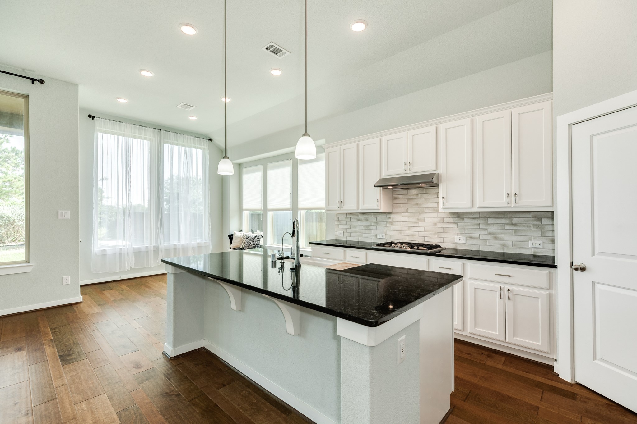 4015 Shackleton Court Iowa Colony, TX 77583 - Photo 14 of 50 Bright, open-concept living and kitchen area featuring expansive windows that fill the space with natural light.