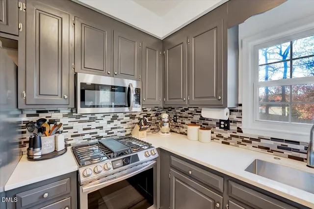 a kitchen with a sink stove and microwave