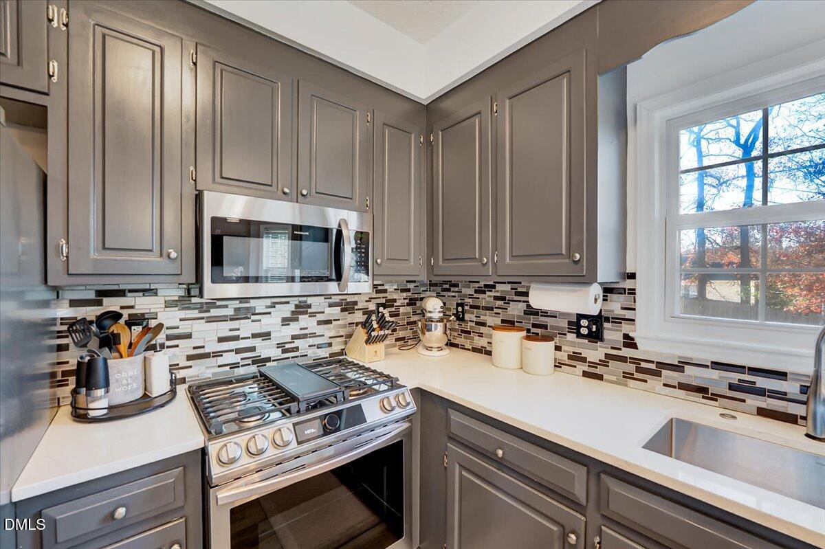 6900 Whittlesea Place Raleigh, NC 27616 - Photo 10 of 39 a kitchen with a sink stove and microwave