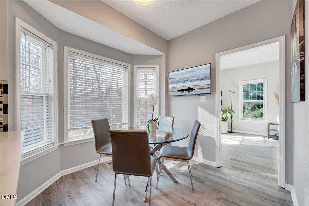 6900 Whittlesea Place Raleigh, NC 27616 - Photo 11 of 39 a dining room with furniture and wooden floor