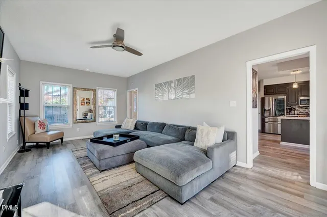 a living room with furniture and wooden floor