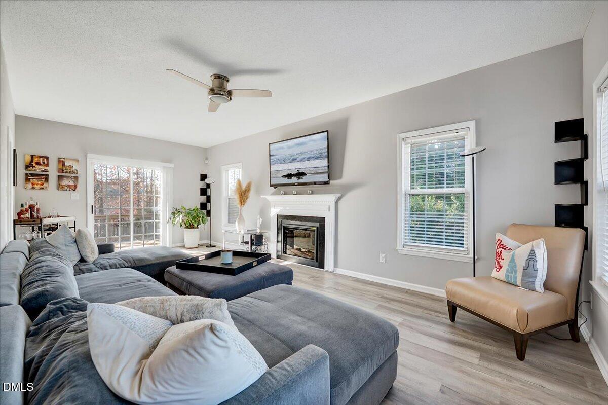 6900 Whittlesea Place Raleigh, NC 27616 - Photo 14 of 39 a living room with furniture fireplace and a large window