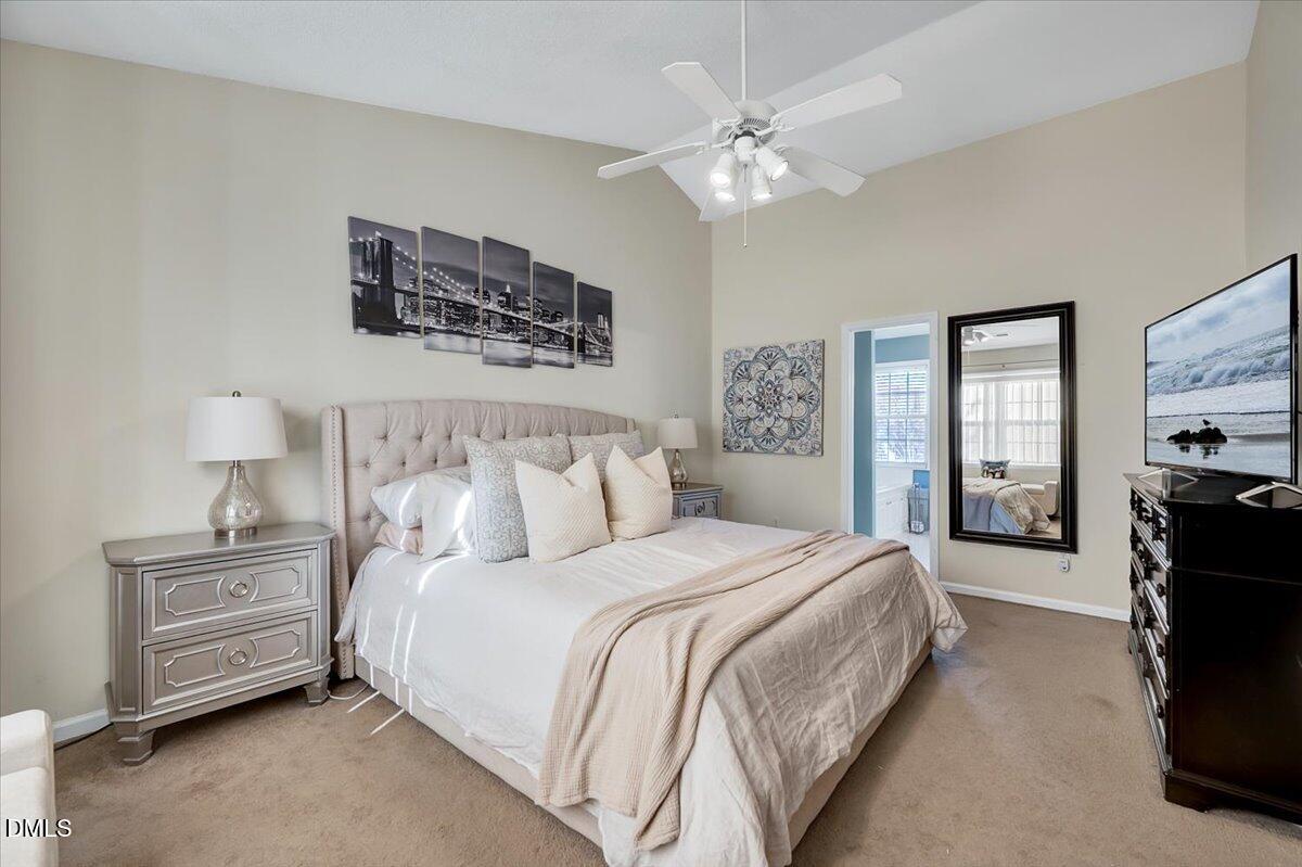 6900 Whittlesea Place Raleigh, NC 27616 - Photo 15 of 39 a spacious bedroom with a bed a couch and dresser