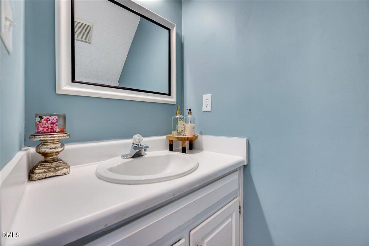 6900 Whittlesea Place Raleigh, NC 27616 - Photo 16 of 39 a bathroom with a sink and a mirror