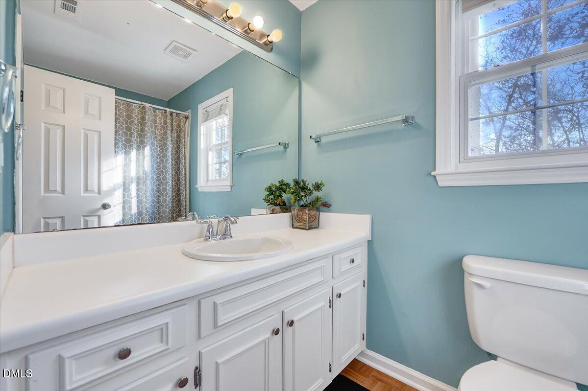 6900 Whittlesea Place Raleigh, NC 27616 - Photo 21 of 39 a bathroom with a sink a toilet and mirror