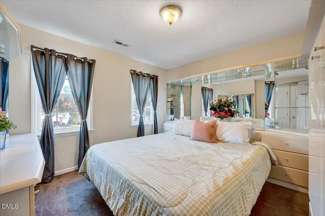 a bedroom with a large bed and a dresser