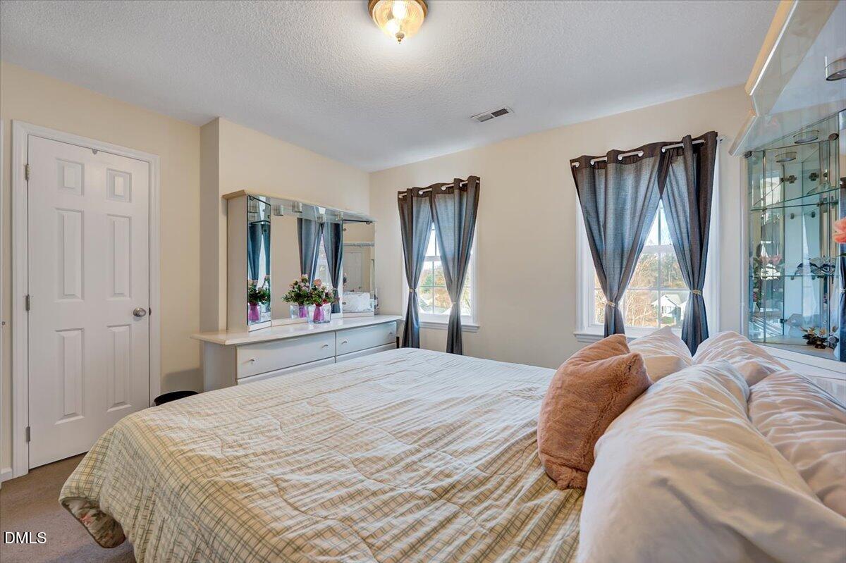 6900 Whittlesea Place Raleigh, NC 27616 - Photo 23 of 39 a bedroom with double bed and a window