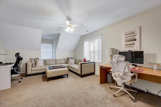 a view of a livingroom with workspace and a window
