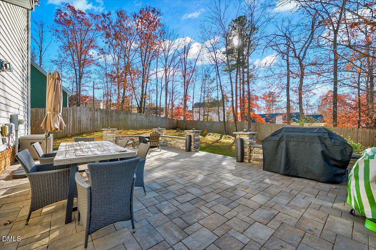 6900 Whittlesea Place Raleigh, NC 27616 - Photo 29 of 39 a view of a patio with table and chairs with wooden fence