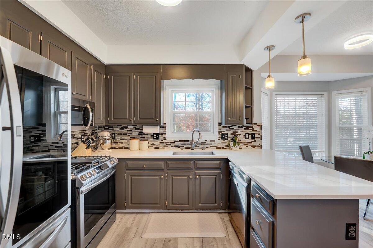6900 Whittlesea Place Raleigh, NC 27616 - Photo 5 of 39 a kitchen with a sink stove and cabinets