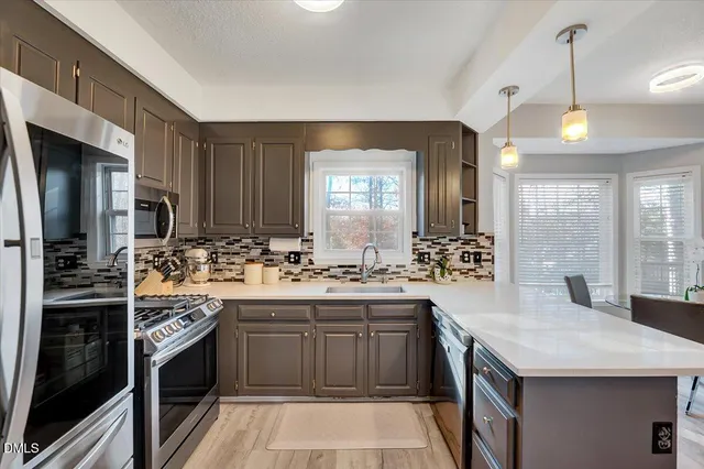 a kitchen with a sink stove and cabinets