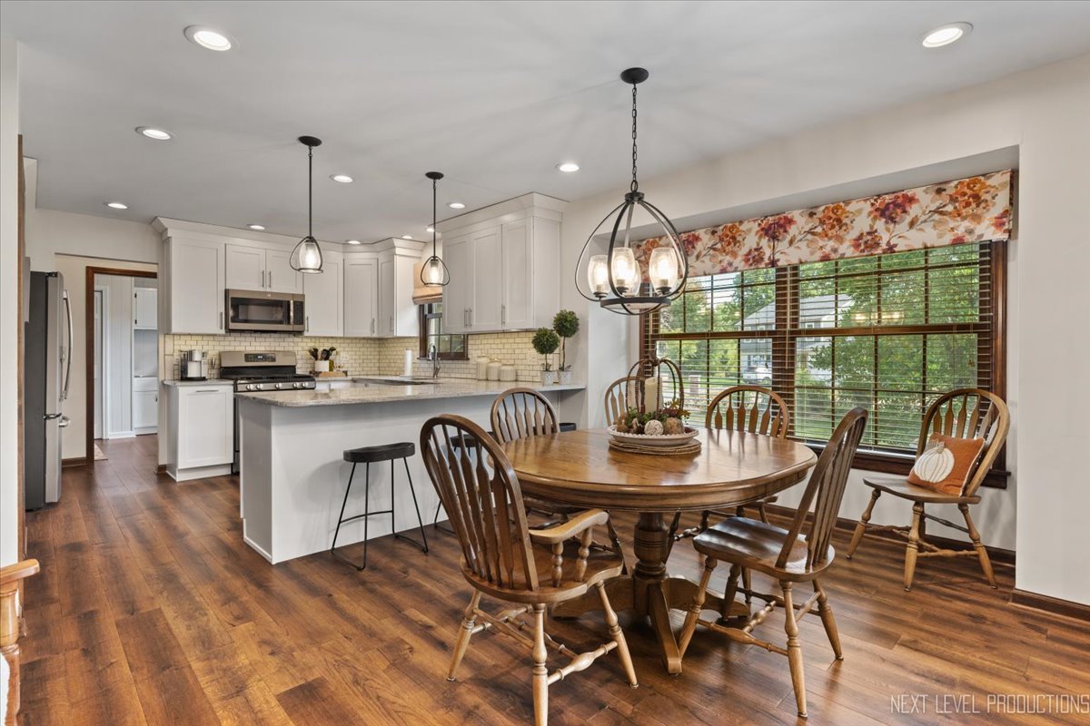 78 South Stauffer Drive Naperville, IL 60540 - Photo 12 of 31 a view of a dining room and livingroom with furniture wooden floor a chandelier