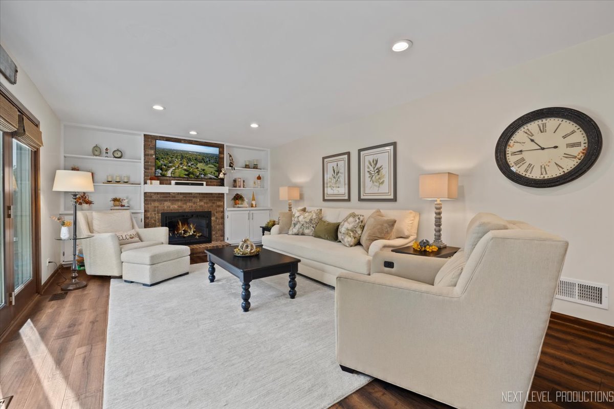 78 South Stauffer Drive Naperville, IL 60540 - Photo 13 of 31 a living room with furniture a fireplace and a wall painting