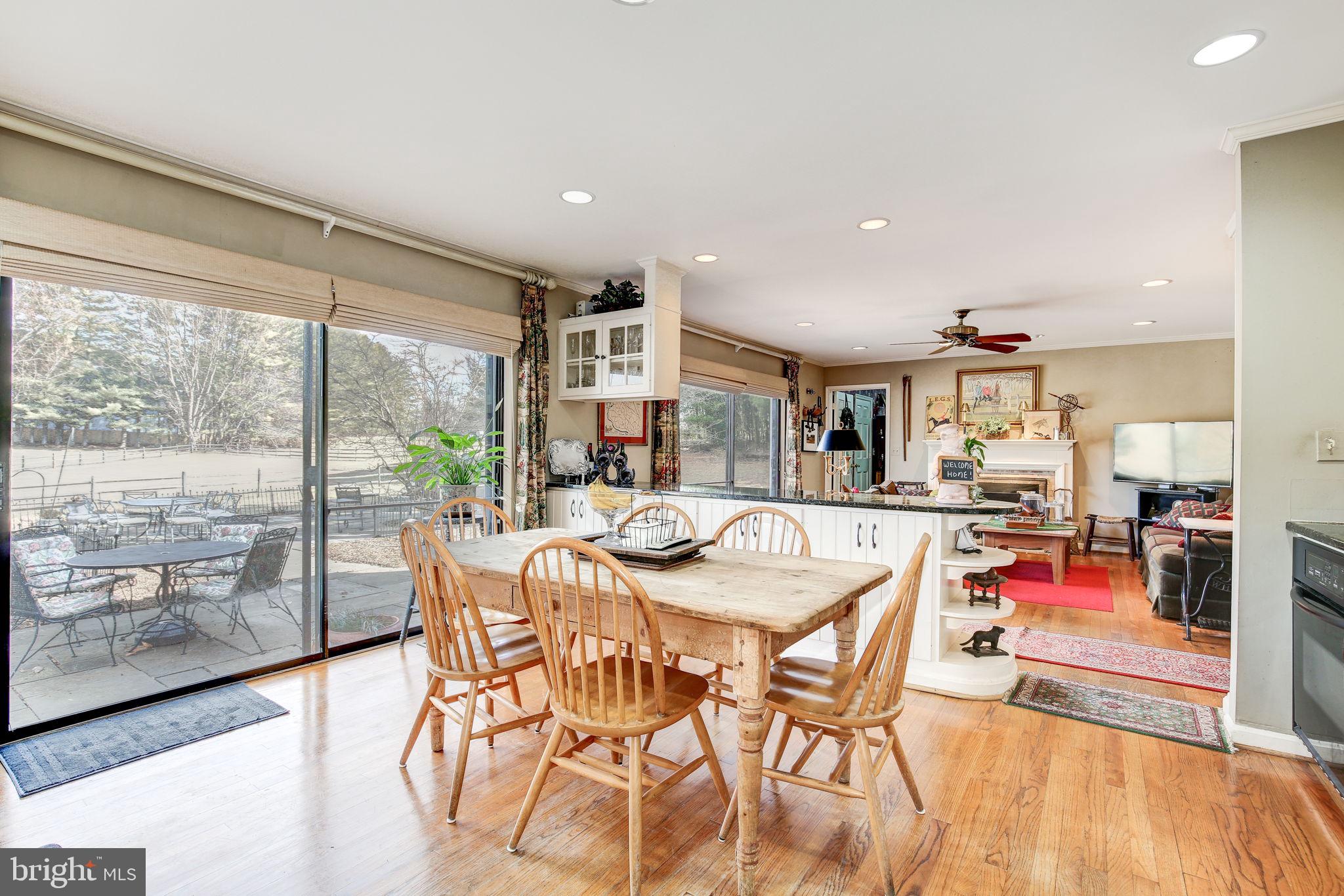 14709 Spring Meadows Drive Darnestown, MD 20874 - Photo 11 of 40 a view of a dining room with furniture wooden floor and a rug