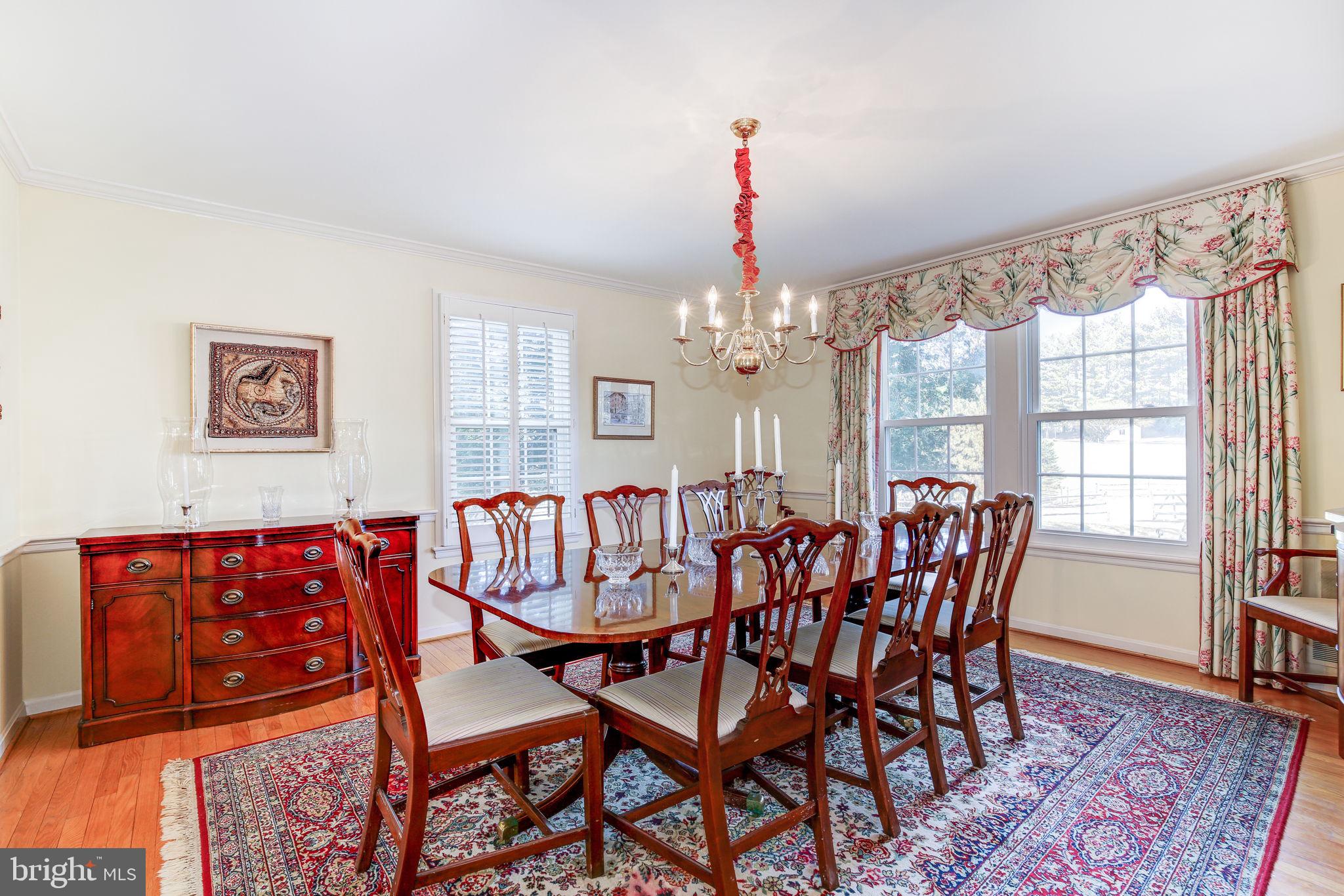 14709 Spring Meadows Drive Darnestown, MD 20874 - Photo 8 of 40 a view of a dining room with furniture and chandelier