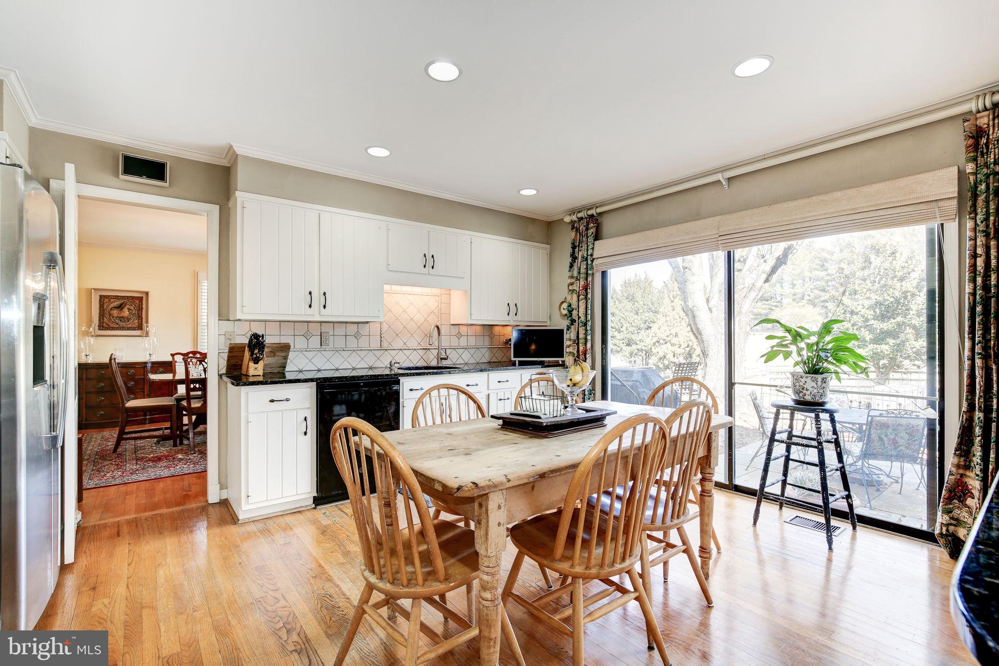14709 Spring Meadows Drive Darnestown, MD 20874 - Photo 9 of 40 a view of a dining room with furniture and wooden floor
