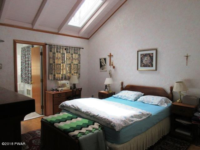 208 Rodeo Drive Hawley, PA 18428 - Photo 7 of 15 a bedroom with a bed and a couch
