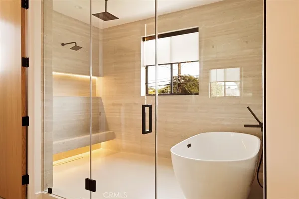 a bathroom with a white bath tub and a shower