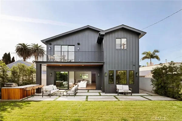 a view of house with swimming pool and furniture