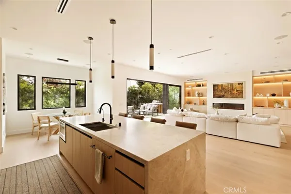 a kitchen with sink stove and refrigerator