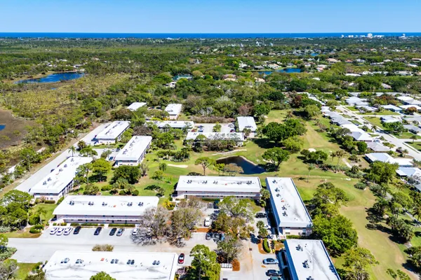 an aerial view of residential houses with outdoor space and swimming pool