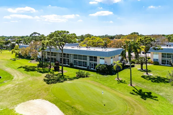 a view of an house with swimming pool and yard