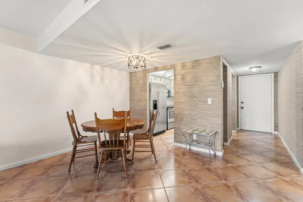 a view of a dining room with furniture and chandelier