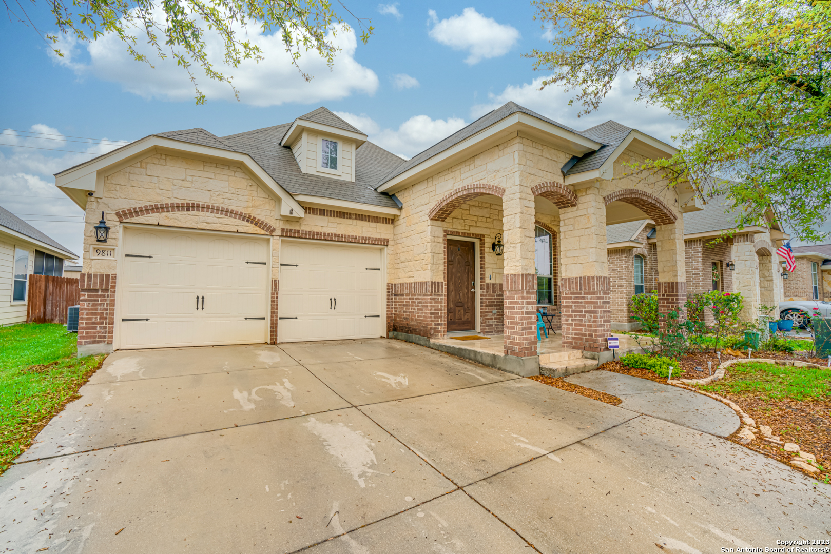 a front view of a house with a yard and garage