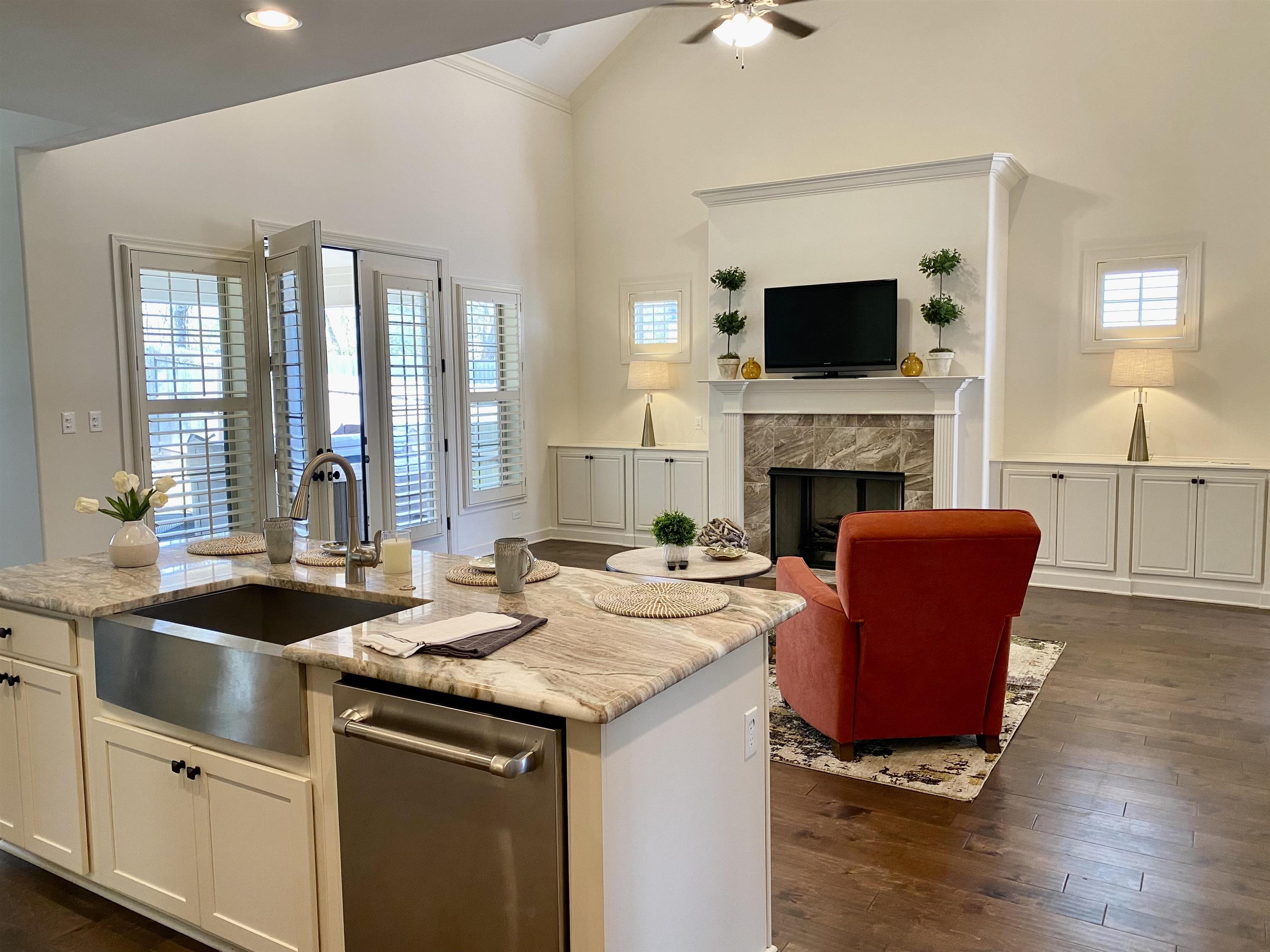 4713 Emmas Circle West Collierville, TN 38017 - Photo 8 of 25 a kitchen with a sink chairs and a fireplace