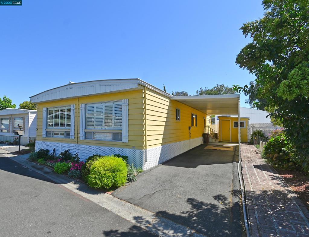 a front view of a house with a yard and outdoor seating