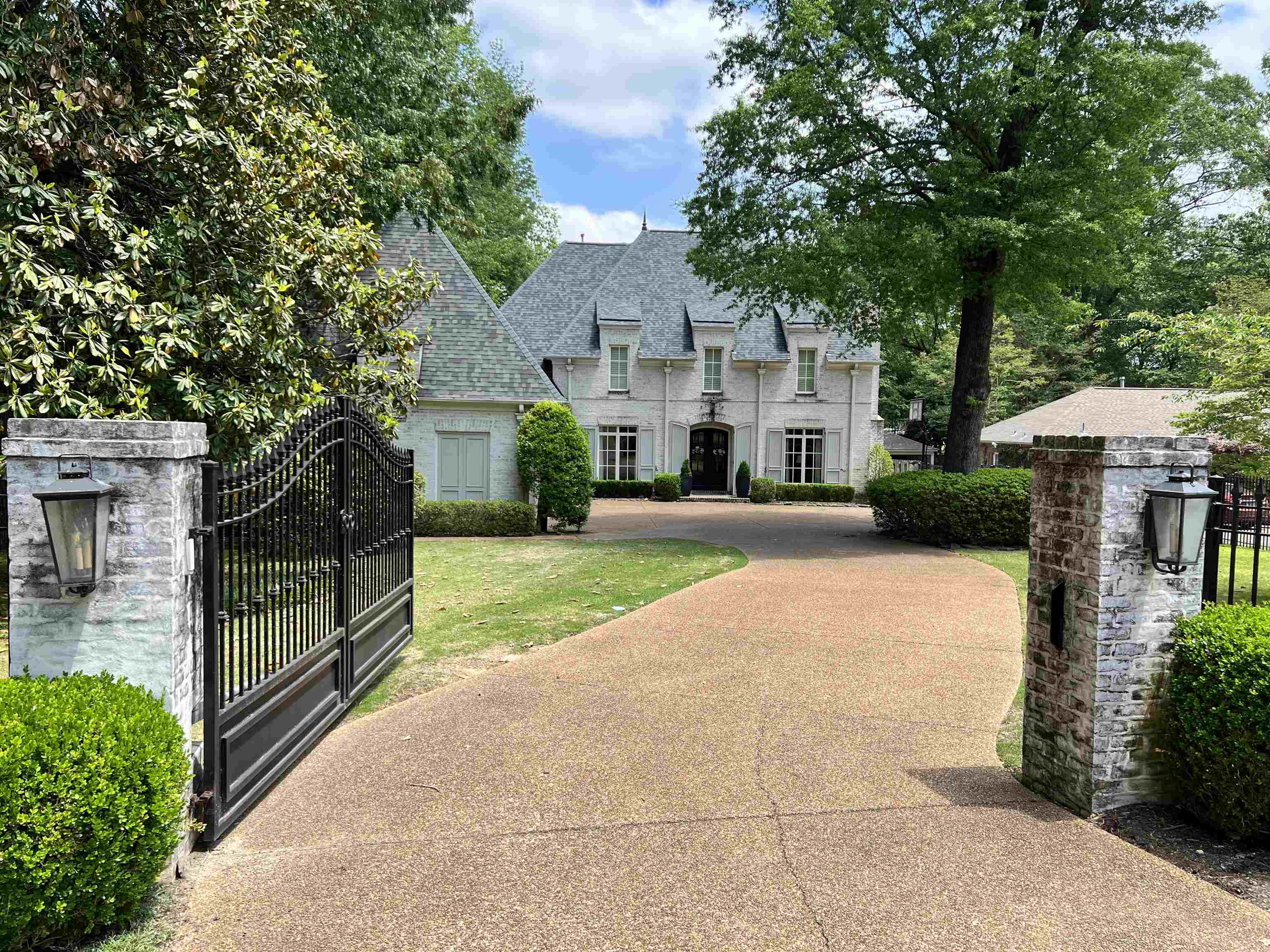 5110 Barry Road Memphis, TN 38117 - Photo 1 of 25 a front view of a house with a yard and potted plants
