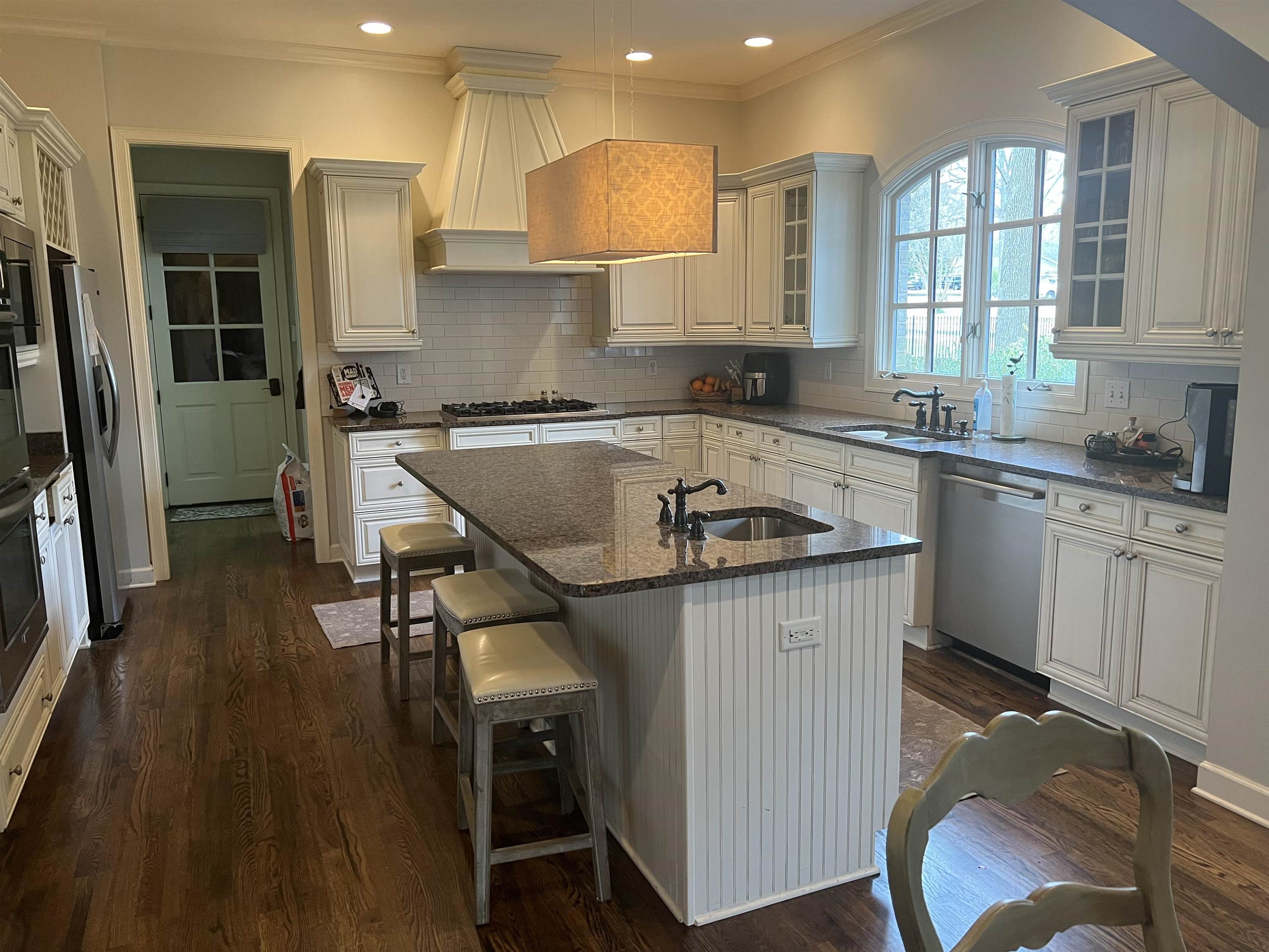 5110 Barry Road Memphis, TN 38117 - Photo 3 of 25 a kitchen with kitchen island a stove a sink a refrigerator and wooden cabinets