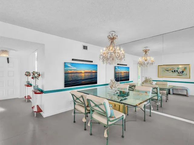 a living room with furniture a rug and a wall painting