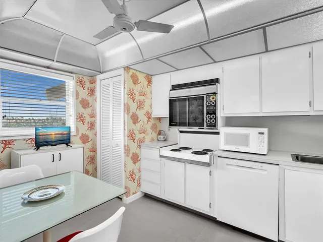 a kitchen with a sink cabinets and window