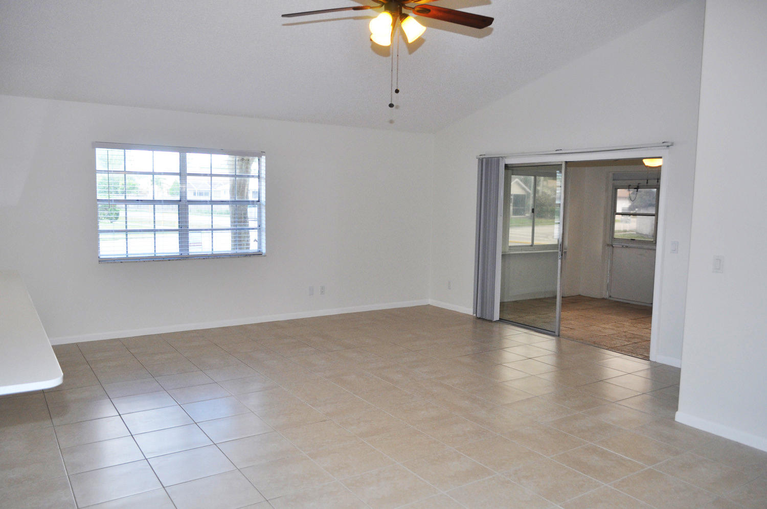 101 Raintree Trail Jupiter, FL 33458 - Photo 9 of 28 LIVING ROOM/ ENCLOSED PORCH