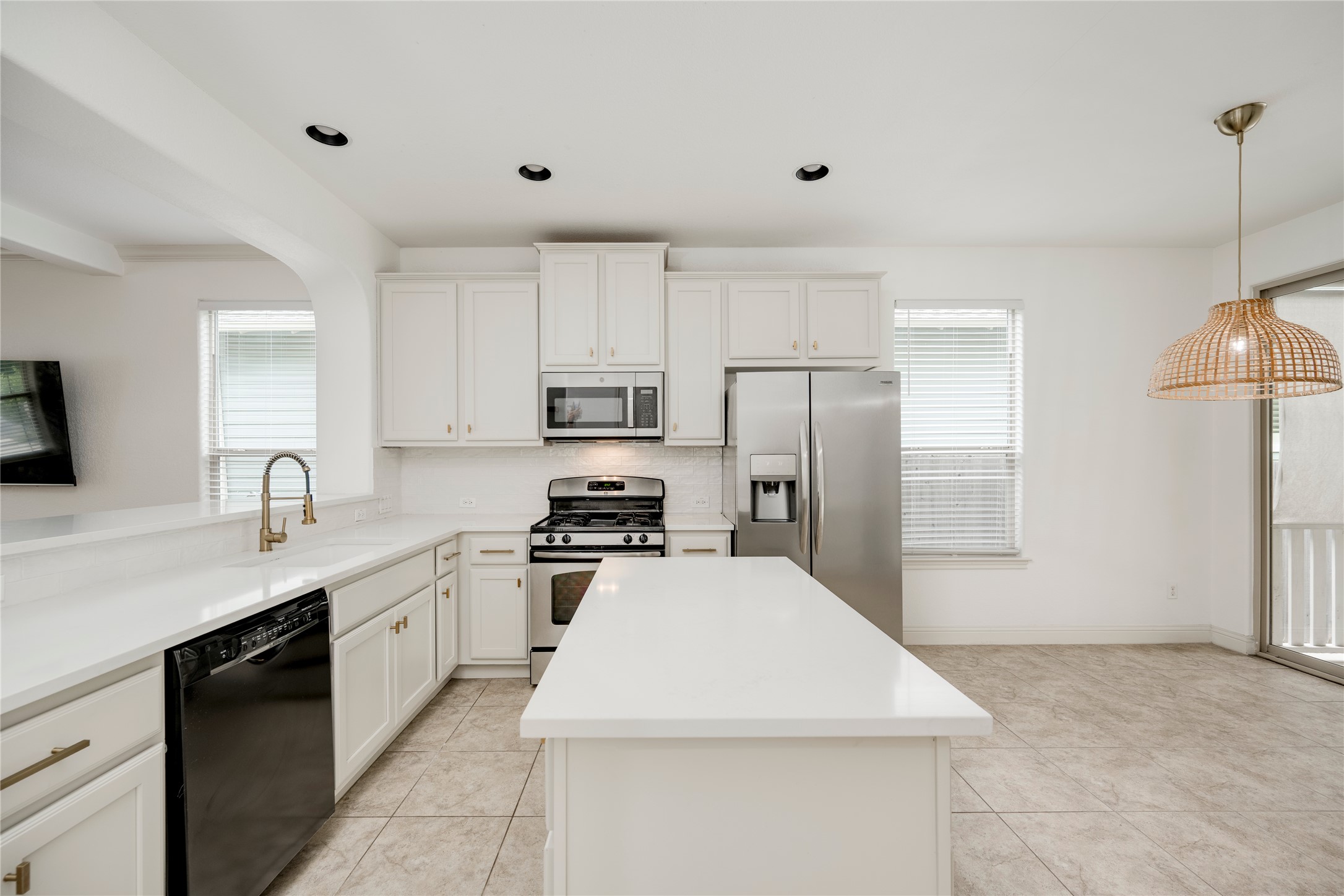 6008 Whipple Way Austin, TX 78745 - Photo 12 of 39 A well-appointed kitchen features a central island, ample cabinetry, and sleek stainless steel appliances.