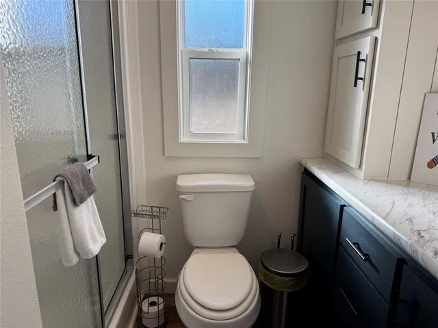a white toilet sitting next to a bathroom sink