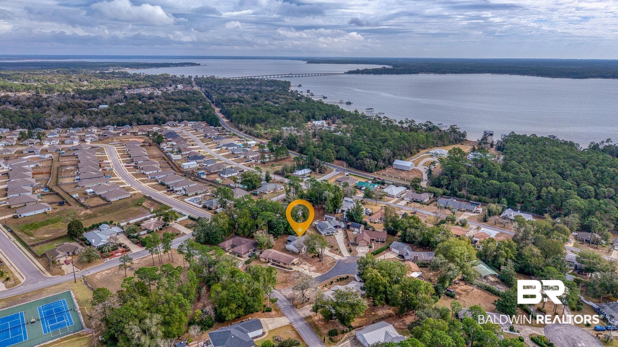 2776 Santa Rosa Circle Lillian, AL 36549 - Photo 5 of 48 Aerial perspective of suburban area with a nearby body of water and a notable bridge