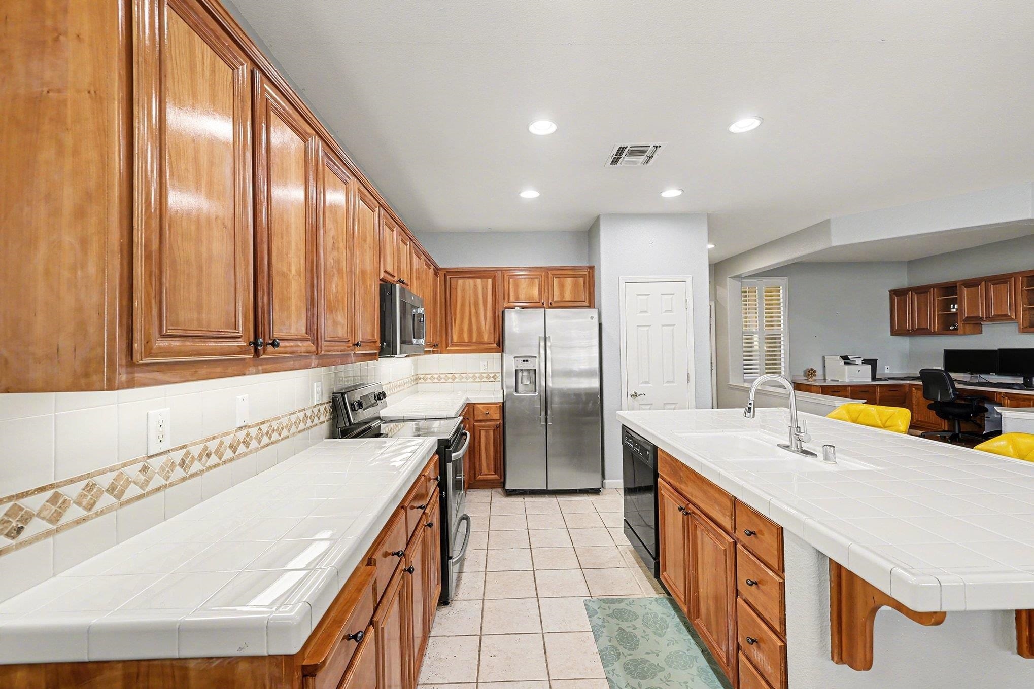 369 Whistling Straits Way Rio Vista, CA 94571 - Photo 11 of 28 a kitchen with stainless steel appliances a sink and a refrigerator