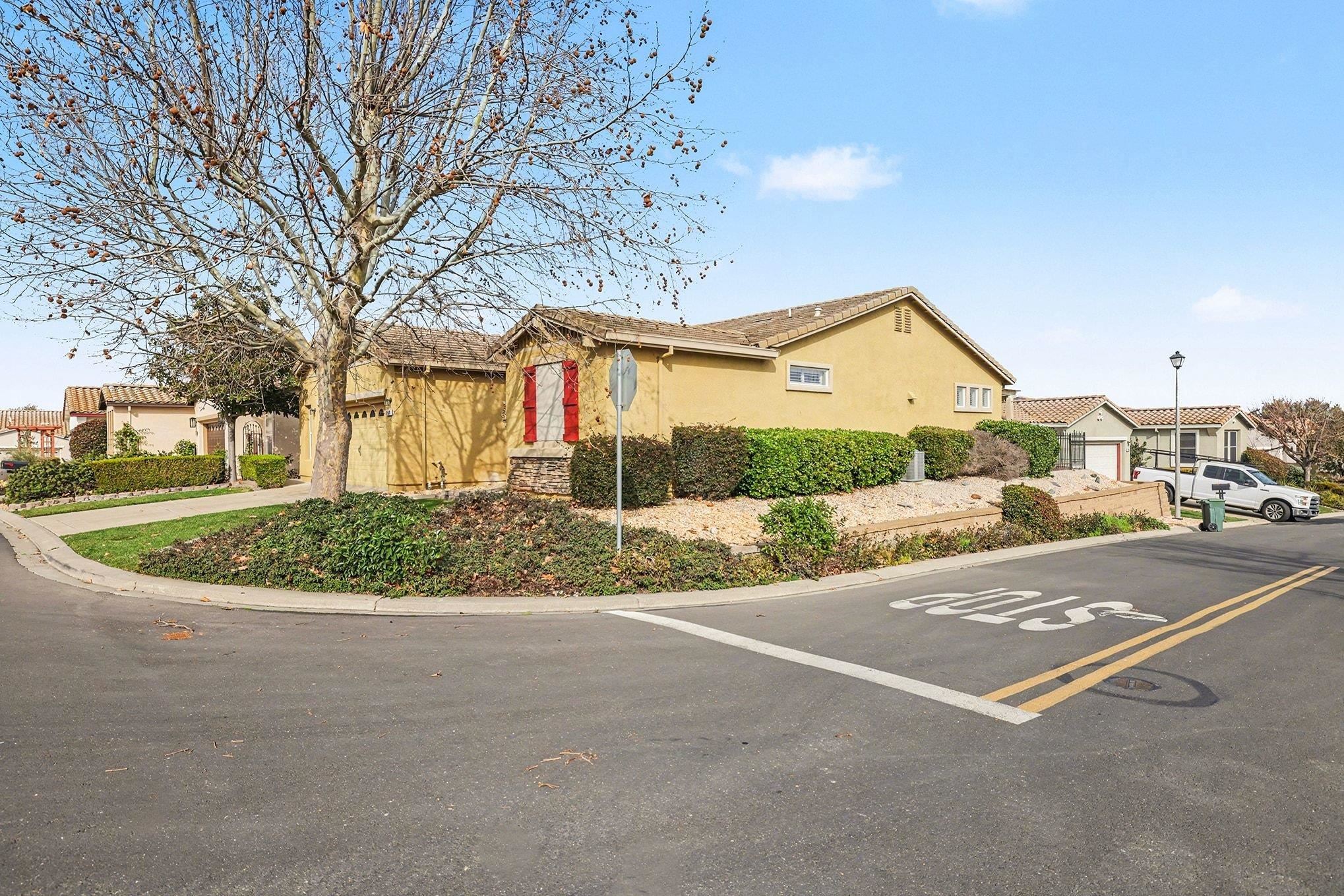 369 Whistling Straits Way Rio Vista, CA 94571 - Photo 5 of 28 a view of a white house with a yard and potted plants