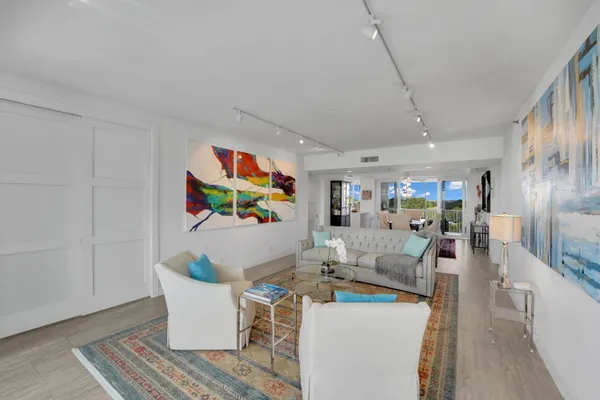 a living room with furniture and a painting on the wall