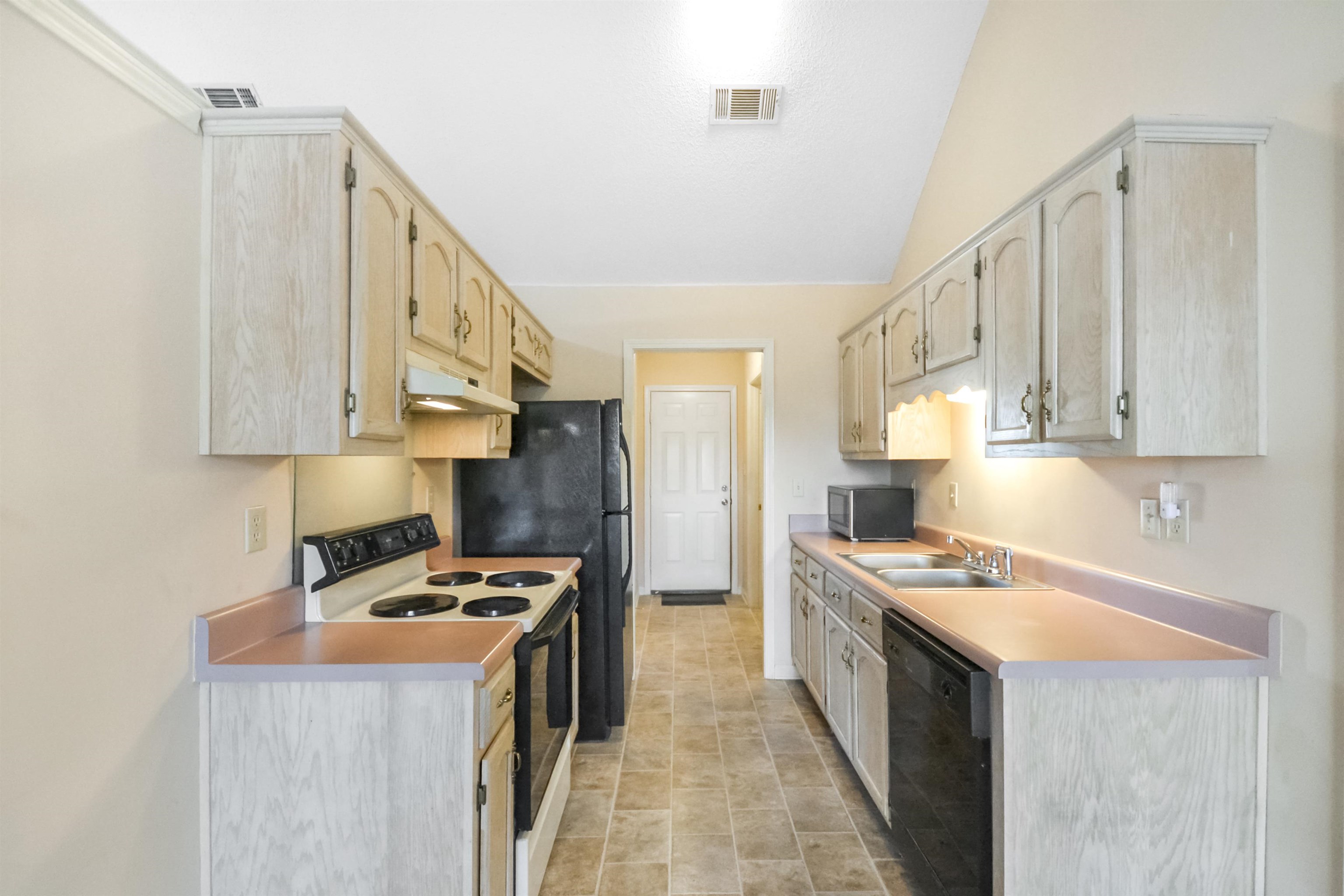 1441 Milestone Circle Collierville, TN 38017 - Photo 18 of 27 a kitchen with stainless steel appliances a stove a sink and a refrigerator