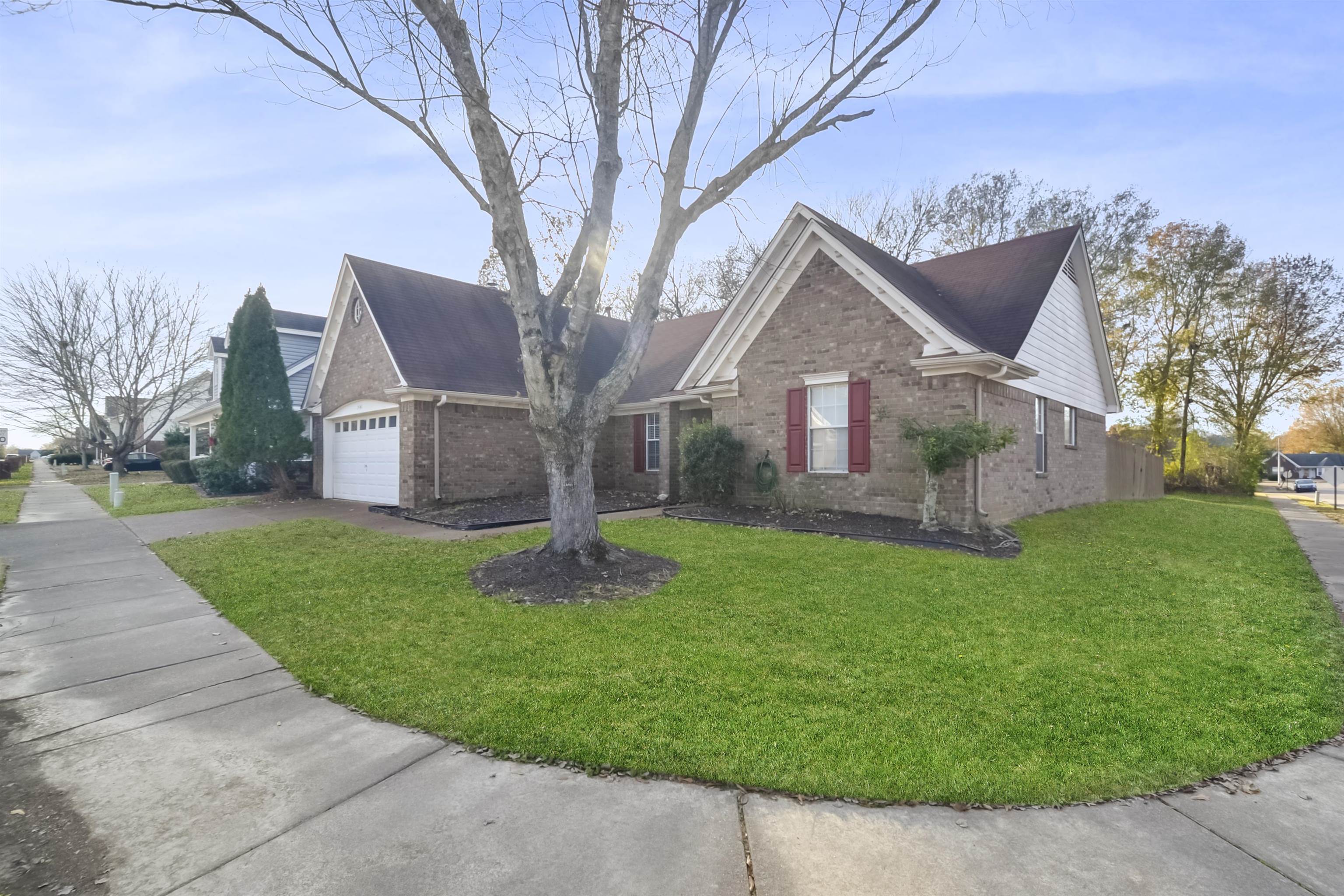 1441 Milestone Circle Collierville, TN 38017 - Photo 2 of 27 a front view of a house with a yard and garage