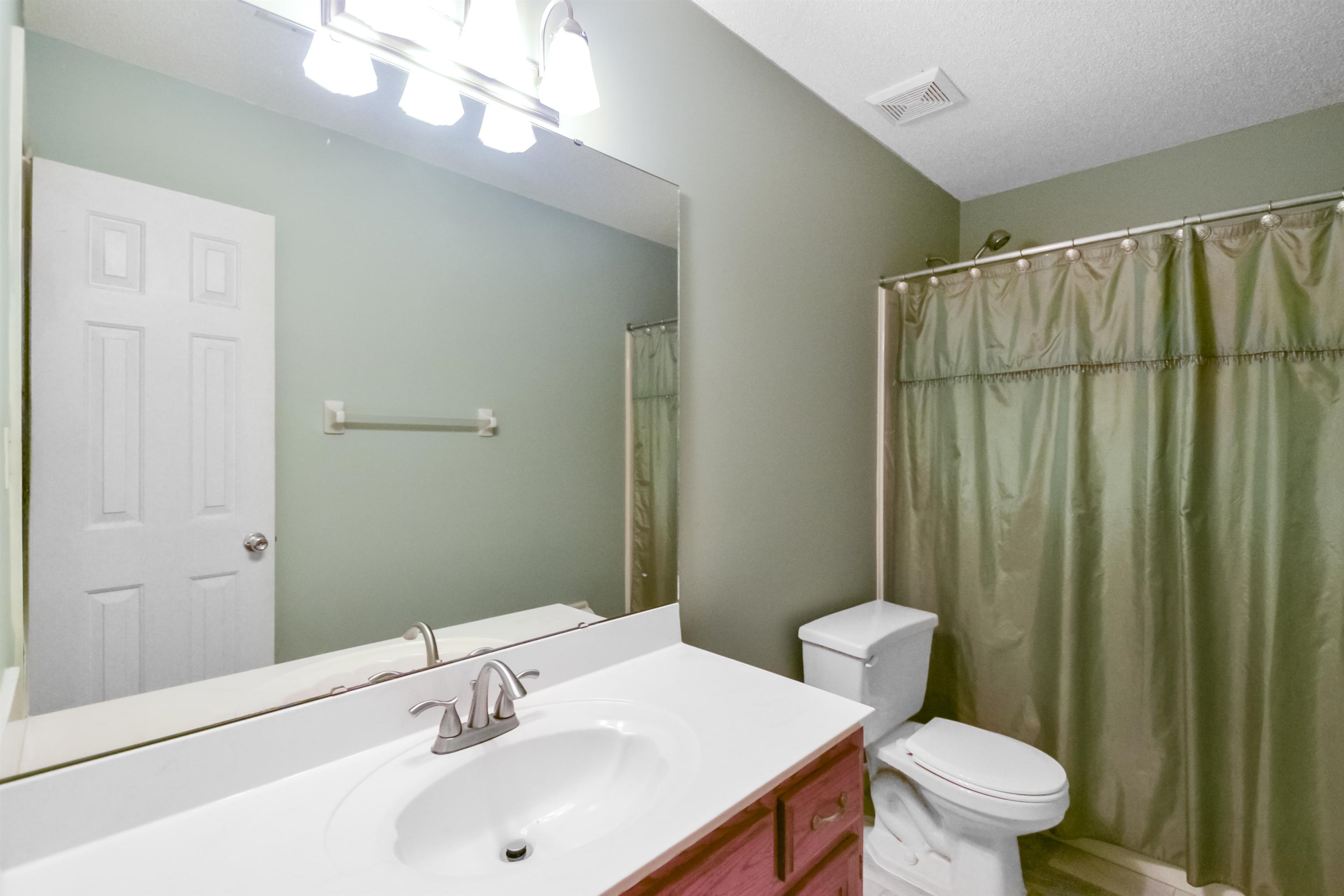 1441 Milestone Circle Collierville, TN 38017 - Photo 23 of 27 a bathroom with a sink a toilet a mirror and shower