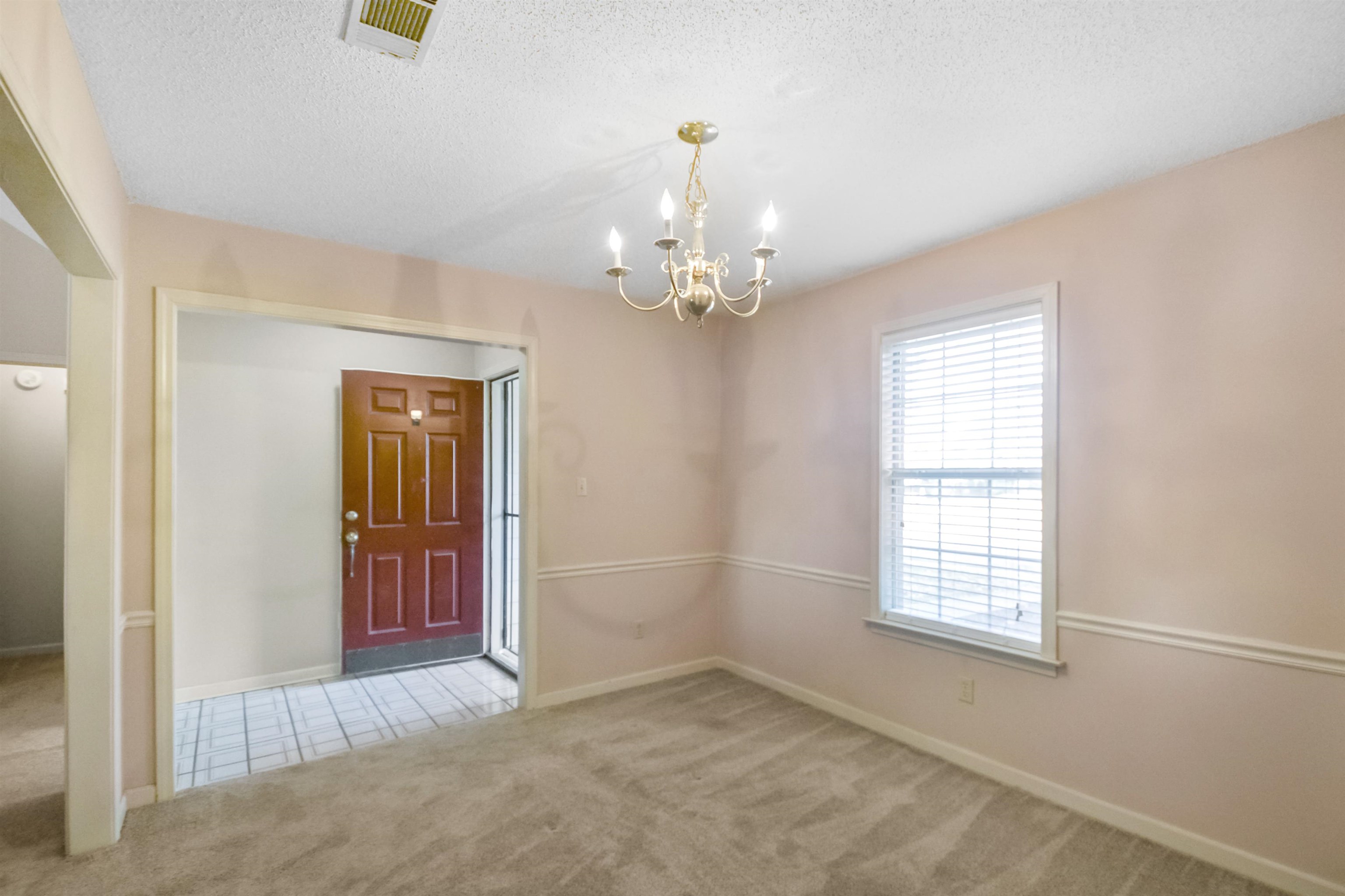 1441 Milestone Circle Collierville, TN 38017 - Photo 3 of 27 an empty room with windows and chandelier fan