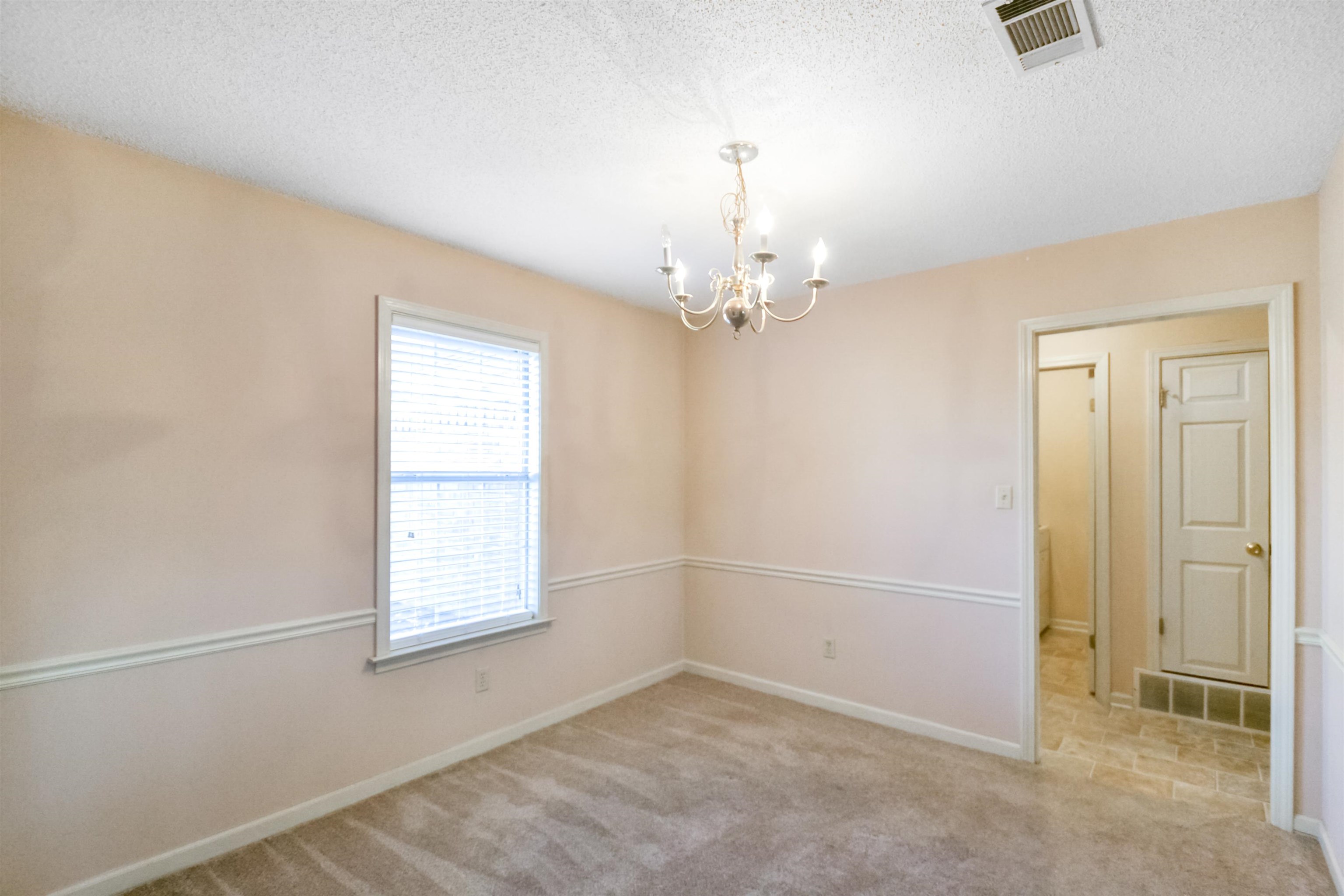1441 Milestone Circle Collierville, TN 38017 - Photo 5 of 27 an empty room with chandelier fan and windows