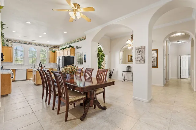 a kitchen with stainless steel appliances granite countertop a refrigerator a sink a stove and island