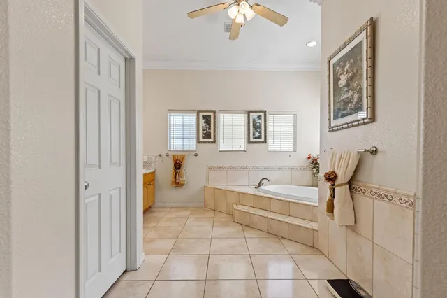 a view of a patio with couches table and chairs with wooden floor and fence