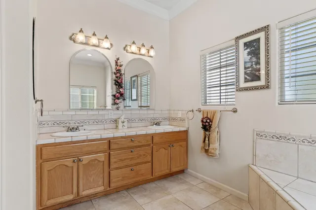 a view of a patio with table and chairs potted plants with floor to ceiling window